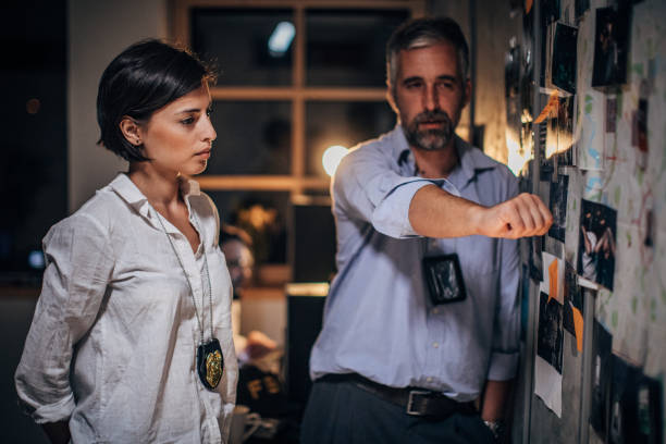 istock Two FBI agents looking for clues in office 1177420938