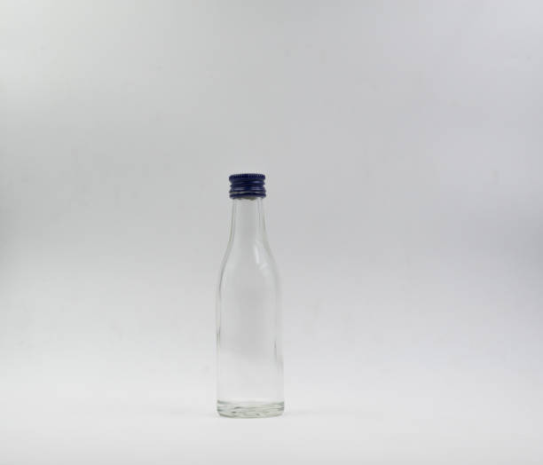 istock Small transparent glass bottle on a white background. 1177421030