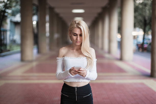 Cute, blonde girl texting. Belgrade, Serbia