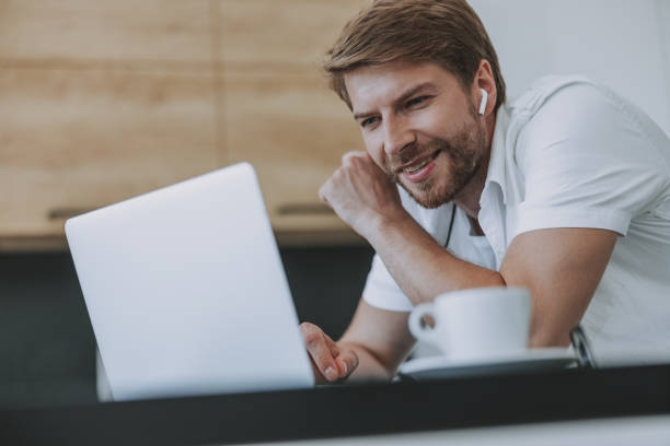istock Young man reading a message on his laptop 1177421855