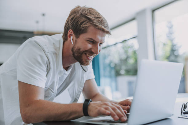istock Smiling man communicating with his coworkers on Internet 1177421959