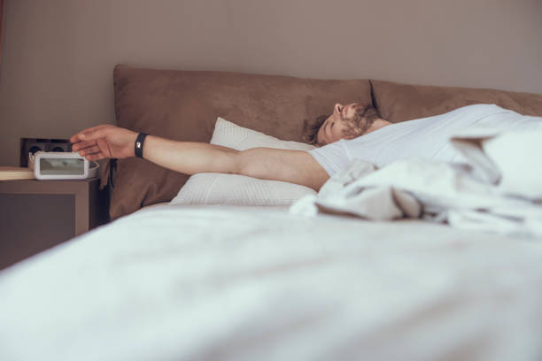 istock Young male sleeping alone in his bed 1177422929