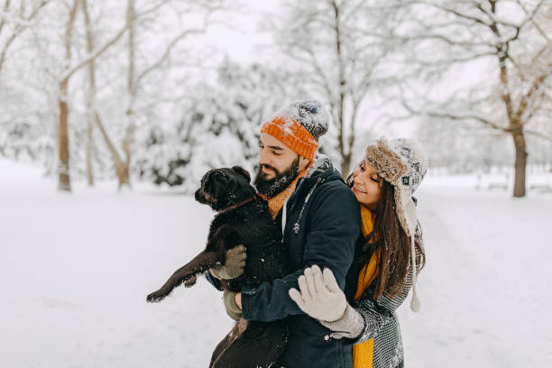 istock Happy young couple having fun in snow 1177424684
