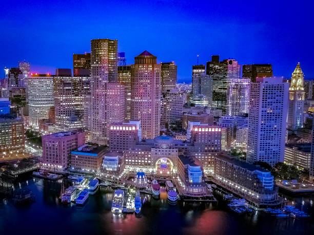 Aerial View of Boston’s city lights Boston, Massachusetts from a drones point of view boston skyline night skyscraper stock pictures, royalty-free photos & images