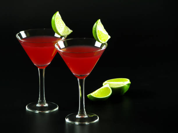 istock Bright red Bacardi alcoholic cocktail and cut in half lime on a dark background 1177428961
