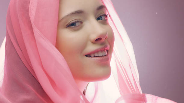 istock Cheerful woman playing with silken scarf 1177432825