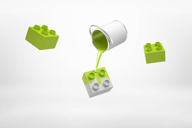 3d rendering of small silver paint bucket turned upside down with green paint pouring on plastic block pieces isolated on white background