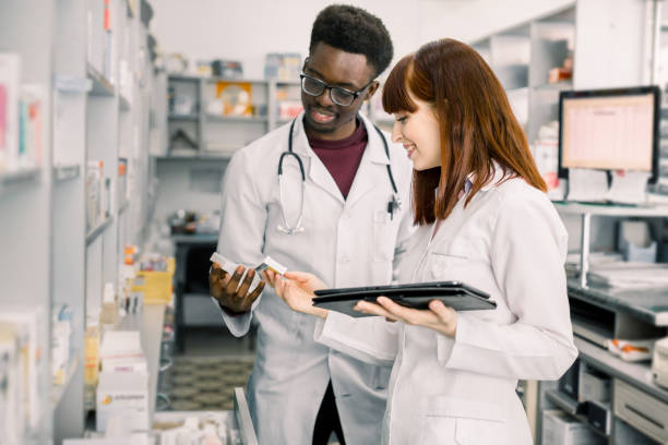 istock Two pharmacists checking inventory at hospital or community pharmacy. Drug quality control. Stocktaking in drugstore. 1177434332