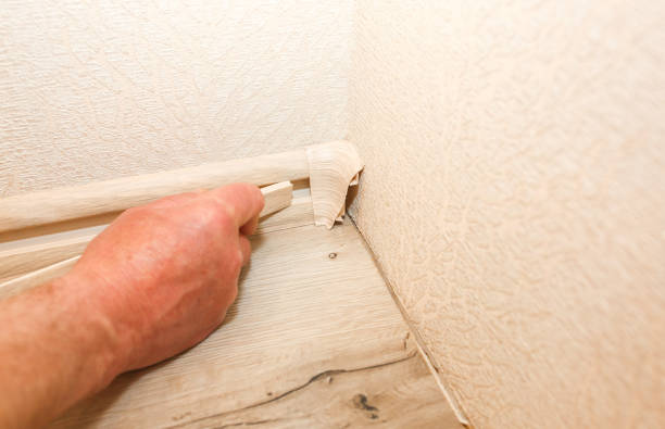 istock Man is installing the baseboard. Repair works indoors. Renovation in the flat. 1177438552