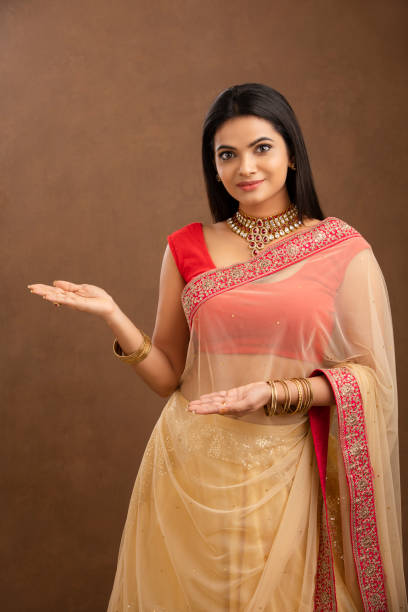 Indian young girl greeting in Traditional saree Indian young girl greeting in Traditional saree studio shot. beautiful traditional indian girl stock pictures, royalty-free photos & images