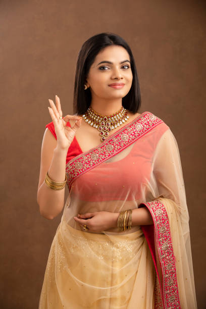 Pretty Indian young girl showing best hand sign. Pretty Indian young Muslim girl showing best hand sign. beautiful traditional indian girl stock pictures, royalty-free photos & images