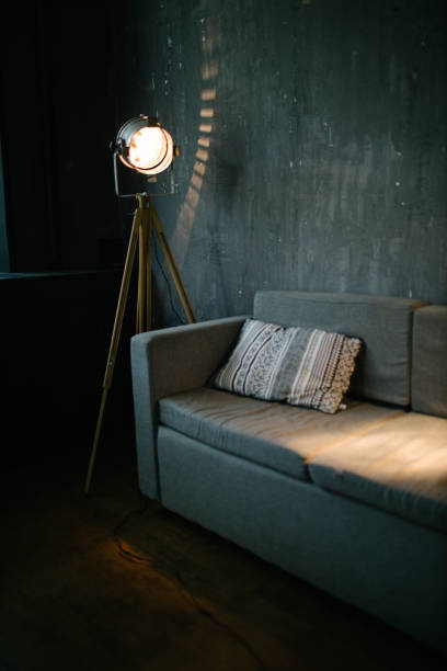 istock Sofa in dark room interior lit by light equipment 1177440436