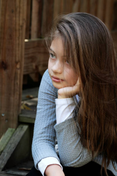 istock Beautiful Young Girl Sitting on Steps 1177442112