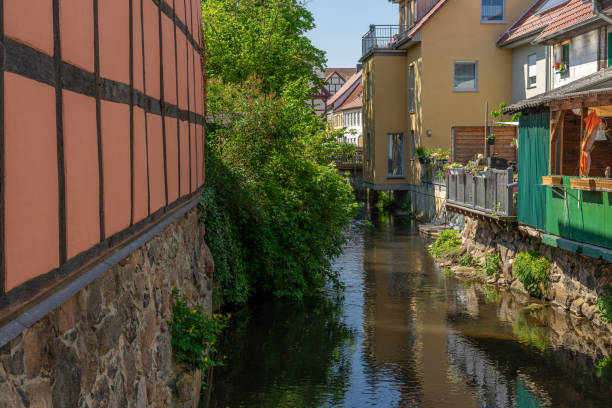 istock A small river with a green shore through a small town 1177442162