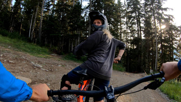 istock Female mountain looks back from path in forest 1177442419