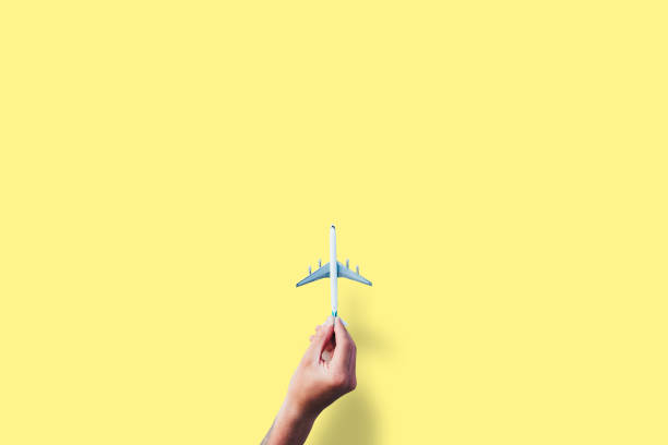 istock Hand holding metal model of airplane with space for text 1177443879