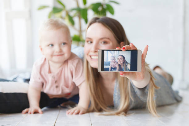 istock young mother hugging toddler making a selfie on the smartphone 1177443949