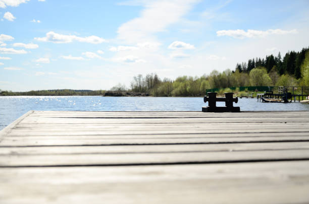 The cross bollard on a wooden pier on a summer day