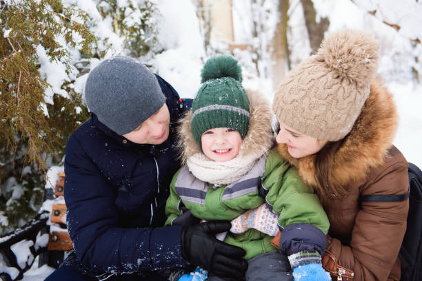 istock happy family having fun and playing with snow in forest 1177445915