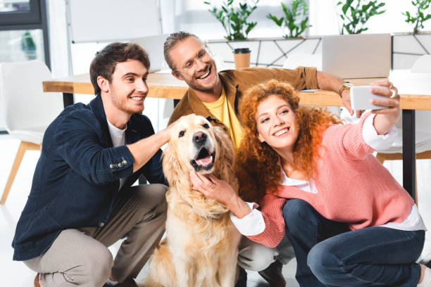 istock three smiling friends taking selfie with cute golden retriever 1177446503