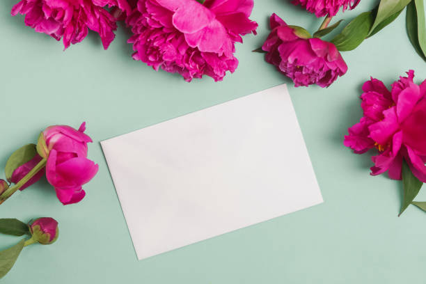 istock Paper card mock-up on the table with beautiful peonies 1177449048