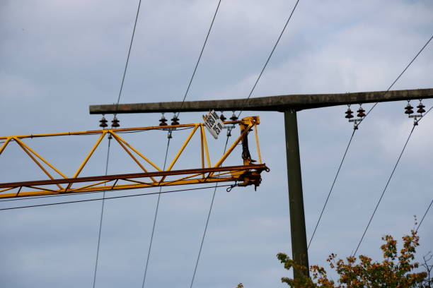 istock Construction crane passes with safety distance under a power line 1177449171