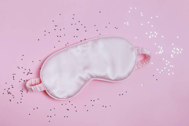 istock Pink sleeping mask on the background with small star shaped confetti 1177450866