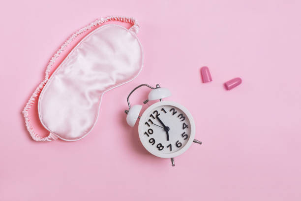 istock Sleeping mask, alarm clock and earplugs pn patel pink background, 1177450870