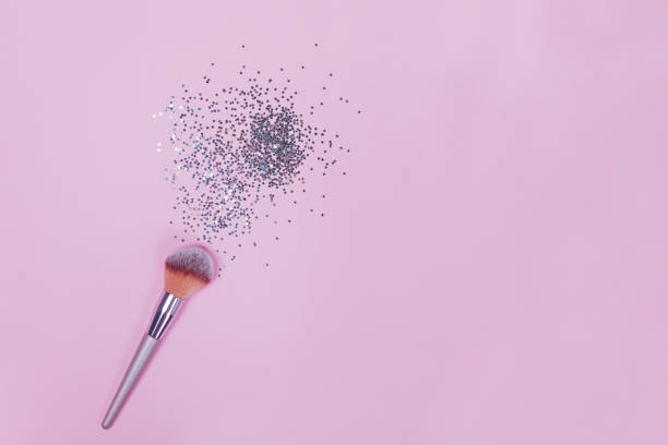 istock Makeup brush and strar shapped small confetti on pastel pink background. 1177450882