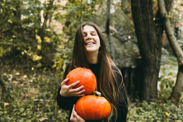 istock Woman with pumpkins preparing for celebrating Halloween 1177452790