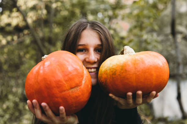 istock Woman with pumpkins preparing for celebrating Halloween 1177454317