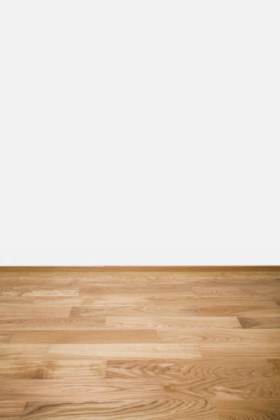 istock Copyspace background with an empty white wall with a hardwood wooden floor below and copy space for your text or advertisement 1177454579