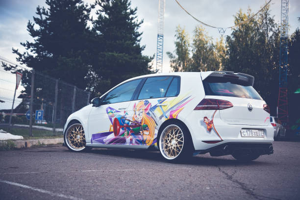 bright white lowered volkswagen golf mk7 parked on street in sunny day. car with painted chip and dale characters on side - editorial land vehicle construction equipment built structure imagens e fotografias de stock