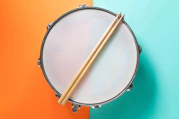 istock Drum stick on color table background, top view, music concept 1177456097