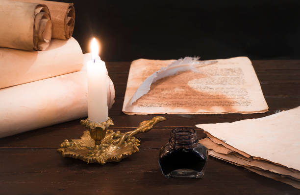 istock A lit candle on the background of blurred scrolls and bird feathers 1177458081