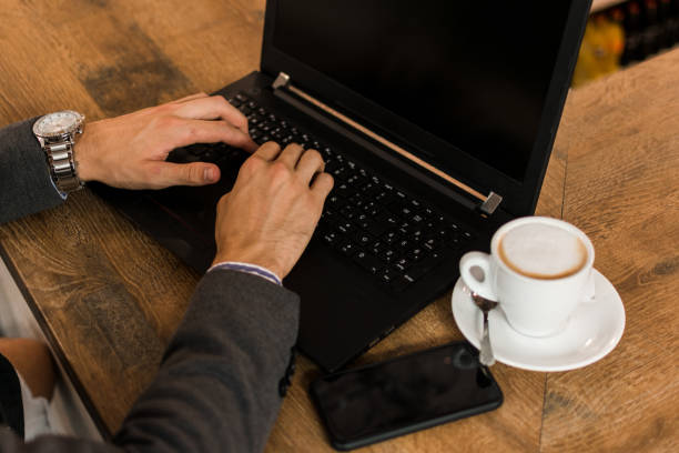 istock Young businessman in a pub working with his laptop 1177460043