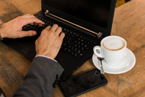 istock Young businessman in a pub working with his laptop 1177460044