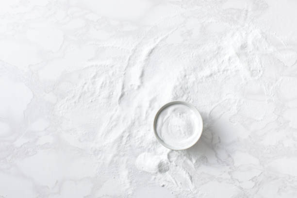 istock Baking soda in a bowl on the marble countertop 1177460549