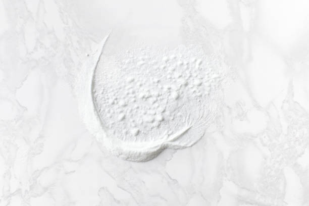 istock Spilled baking soda on a marble table with traces of sponge 1177460671