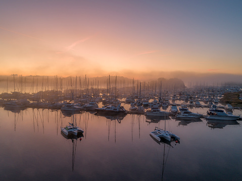 Foggy Sunrise with boats on Brisbane Water at Koolewong and Tascott on the Central Coast, NSW, Australia.