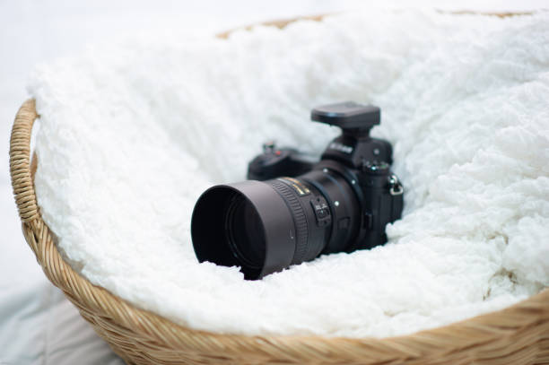 The black camera is well placed in a white cloth.