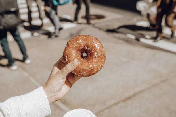 istock Woman having a donut in New York 1177462346
