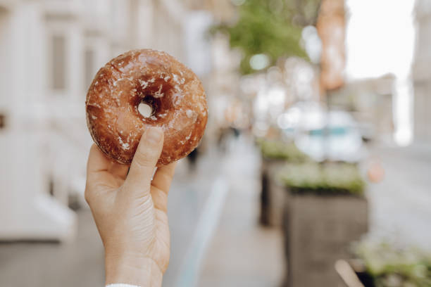 istock Woman having a donut in New York 1177462466