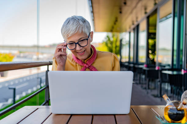 istock Mature business woman at cafe using laptop 1177463659