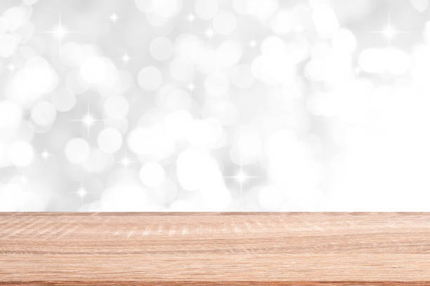 istock abstract blur soft focus bokeh bulbs light in white color background with star glittering and wood table perspective for show,promote and advertisee product and content in merry christmas and happy new year season concept 1177466194