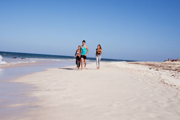 istock People running on a white sandy beach 1177468242