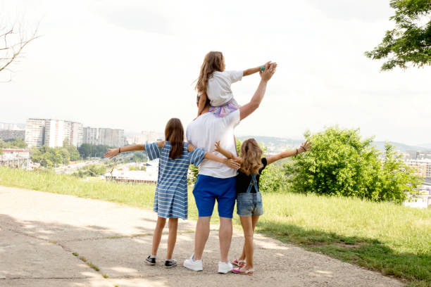 istock Cheerful father playing with his children's in park 1177471678