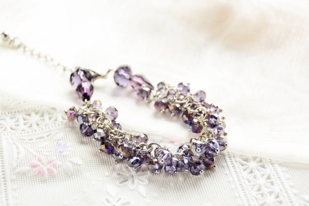 istock Crystal necklace on white fabric background