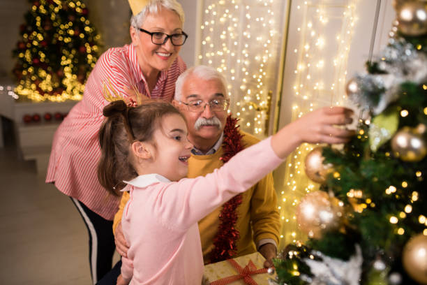 istock Decorating the Christmas tree with grandma and grandpa 1177477965