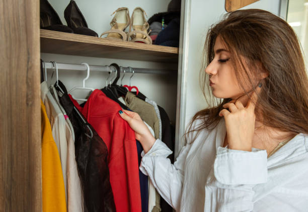 istock Young woman is choosing clothes from her wardrobe 1177479292